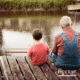 young boy fishing with grandpa off a dock